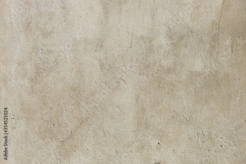 Grey concrete wall with stucco relief pattern.