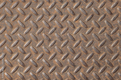 Oval pattern on the surface of the iron rusty walls, which are used as a door or gate because of its sturdy. Closeup.