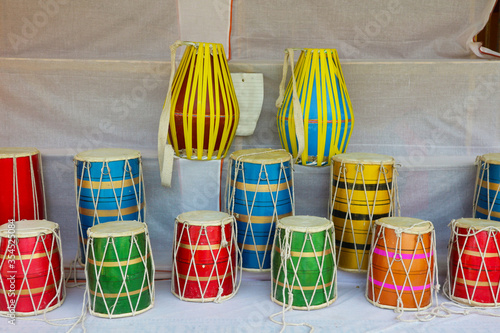 Multi-colored Indian drums. Drums of different sizes and colors are on display. photo