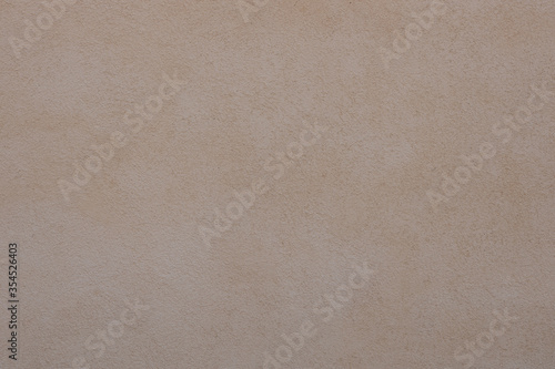 Grungy painted wall with decorative parget white stucco texture background. Structural plaster, rough, uneven surface with textured bumps and marks. photo