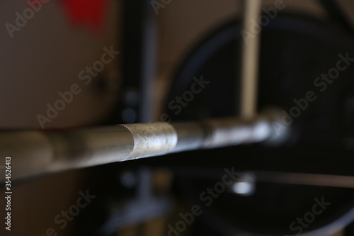 home gym equipment, barbell leaning on the rack