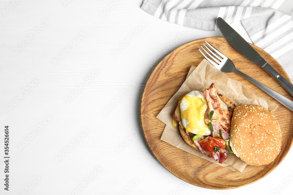 Delicious egg Benedict served on white wooden table, flat lay. Space for text