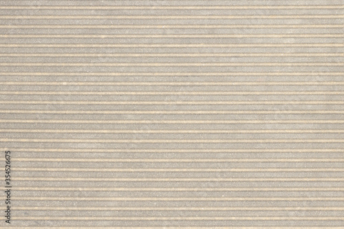 Decorative parget texture background. Wall fragment with horizontal striped pattern. Structural plaster surface in beige gray color.