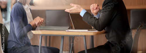 Male financial adviser consulting with female customer in office room