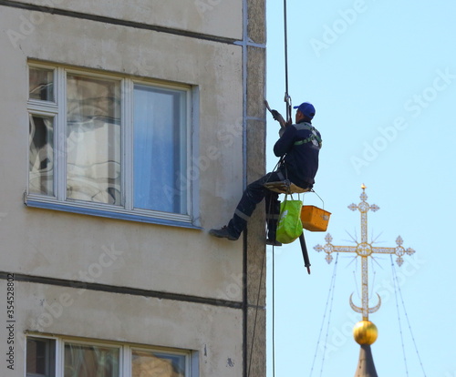 Industrial climber on the wall, ulitsa Kollontay 17, Saint Petersburg, Russia June 2017