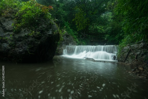 Beautiful shot of a waterfall below Meghalaya Double Root Bridge photo