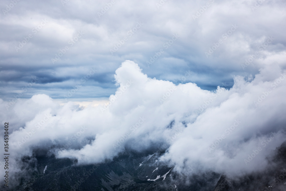 Massive clouds in the mountains. Tatra Mountains with cloudy atmosphere.