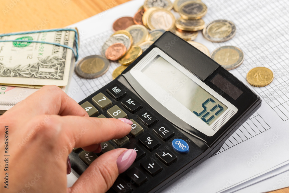 Coin money and banknote bills with a calculator. ballance reduction Coin money and banknote bills with a calculator. ballance reduction