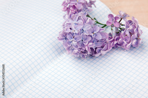 Lilac flowers on a squared exercise-book