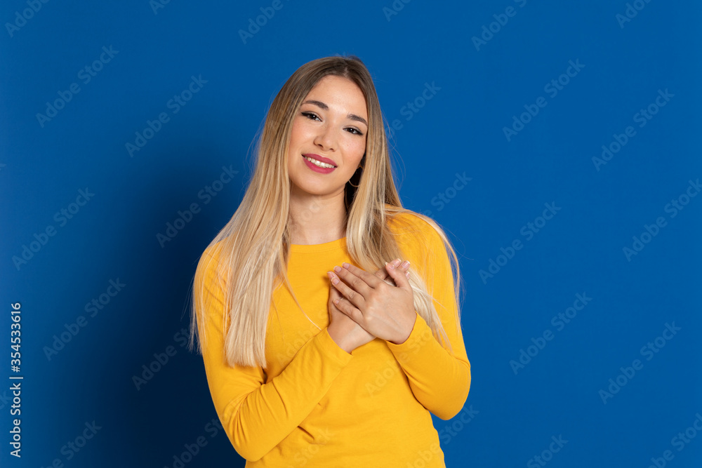 Blonde girl wearing a yellow T-shirt Blonde girl wearing a yellow T-shirt