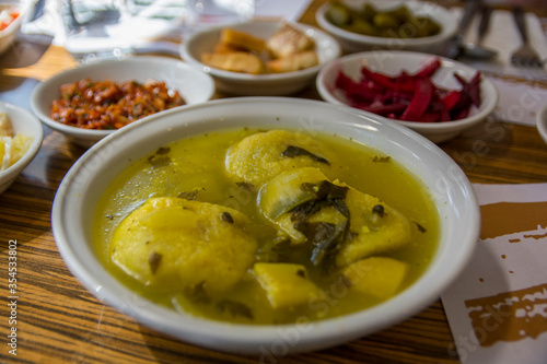 Traditional hot yellow Kubbe soup, a famous middle eastern dumplings soup dish, served in a bowl. Jerusalem, Israel.  photo