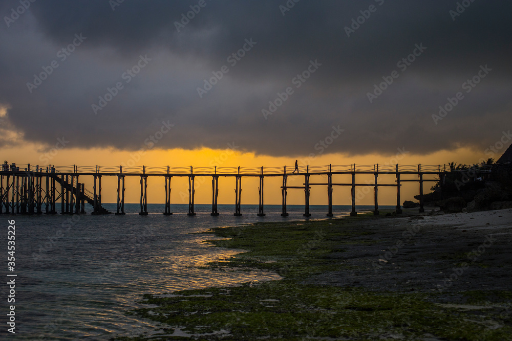 Wooden walkway stretching over the sea at sunrise, Nungwi, Zanzibar, Tanzania