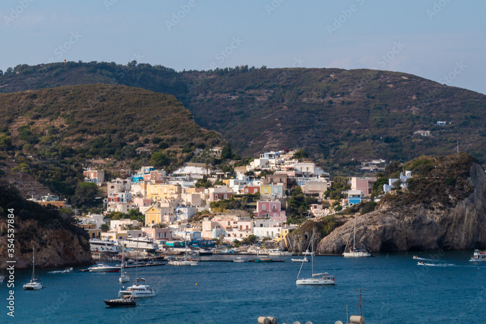 View of the harbor and port at Ponza island in the summer season. The place is typical for its blue water and colo