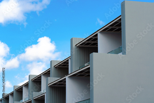 Fragment of modern building against blue sky. Part of residential modern building