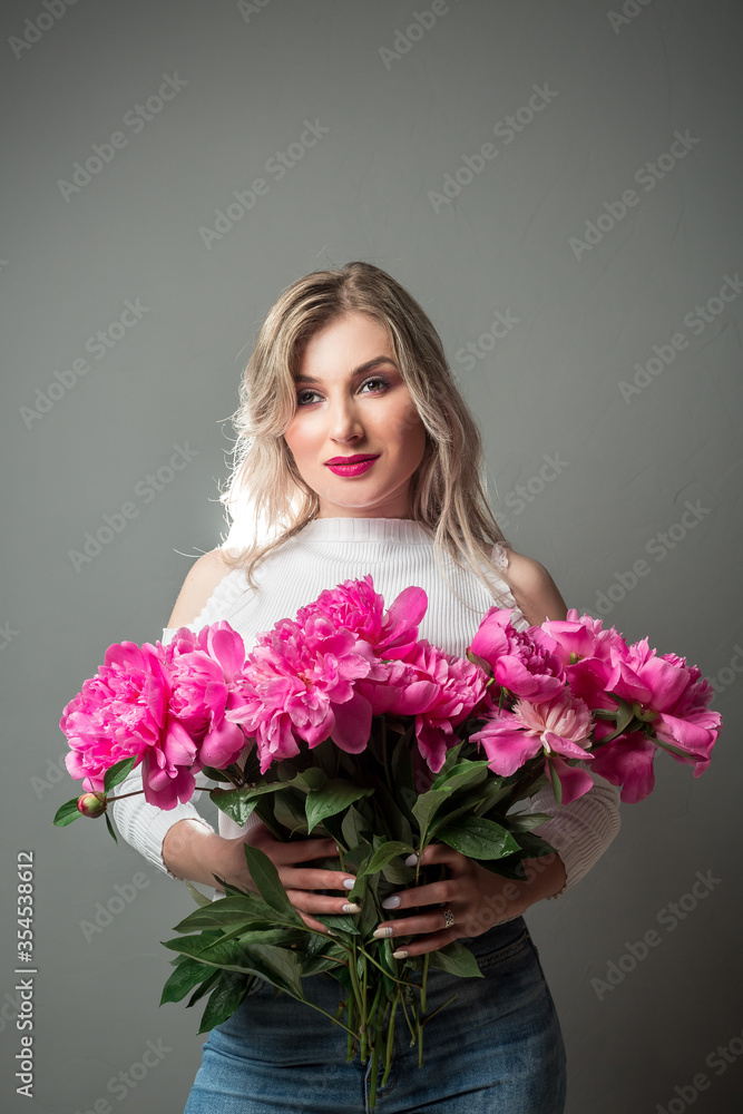 Beautiful woman with flower. Beauty portrait of girl with pink peonies flower. Clean face, care
