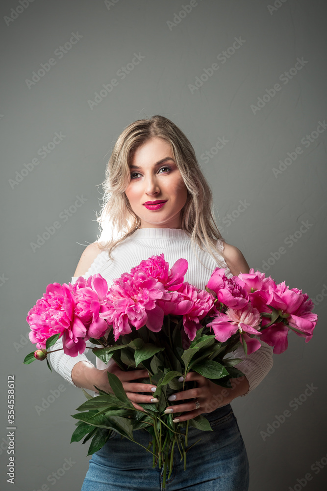 Beautiful woman with flower. Beauty portrait of girl with pink peonies flower. Clean face, care Beautiful woman with flower. Beauty portrait of girl with pink peonies flower. Clean face, care