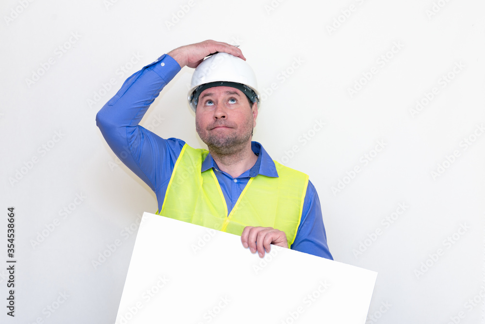 Surprised Engineer man wearing a helmet and reflector vest, standing and holding a billboard. White background. Surprised Engineer man wearing a helmet and reflector vest, standing and holding a billboard. White background.