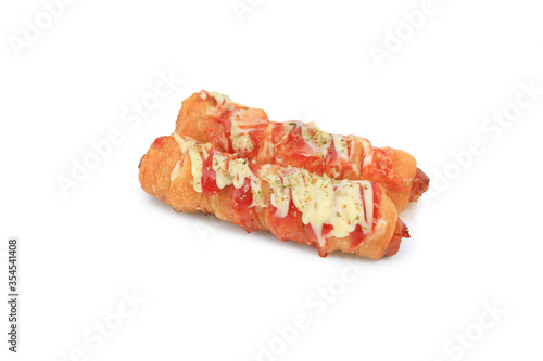 Sausage with mayonnaise and ketchup topping isolated on white background. Hod french dog in dough fast food.