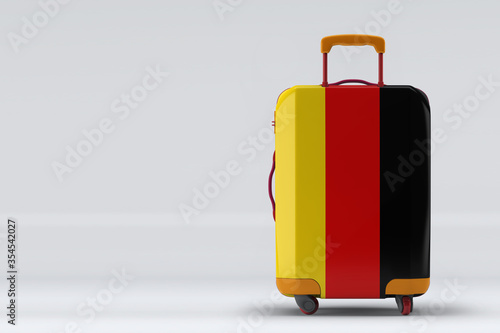 Germany flag on a stylish suitcases back view on color background. Space for text. International travel and tourism concept. 3D rendering.