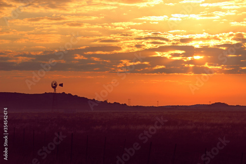 sunset in the mountains with windmill