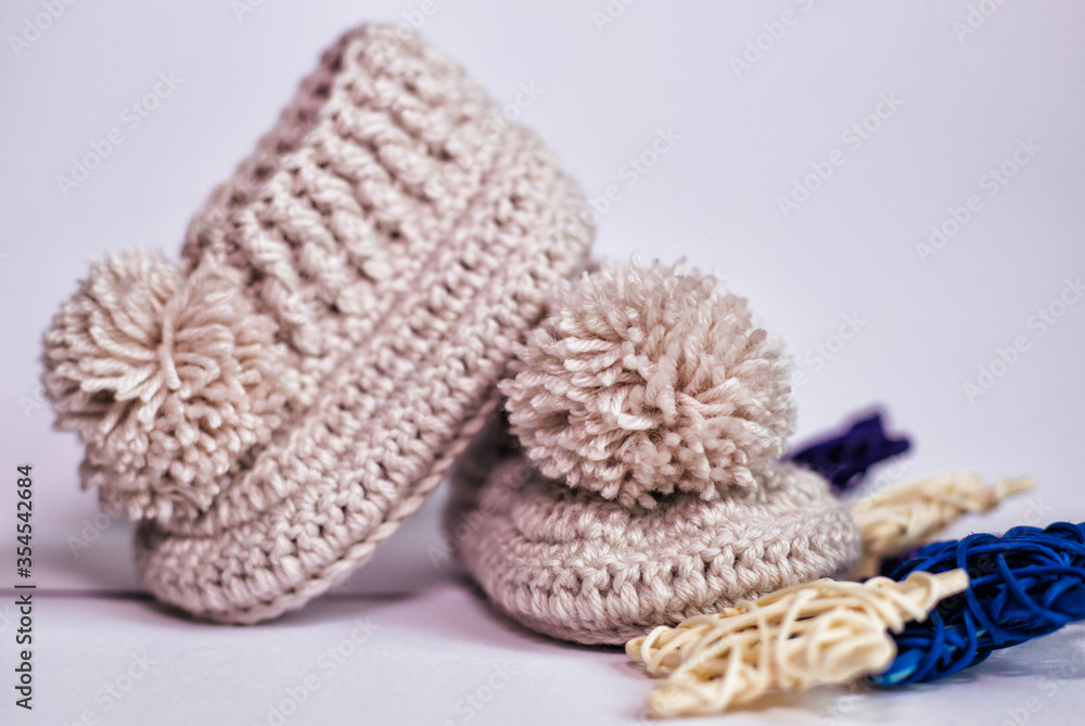 Small children's socks. Booties in gray on a white background. Wool socks for the baby. Small children's socks. Booties in gray on a white background. Wool socks for the baby.