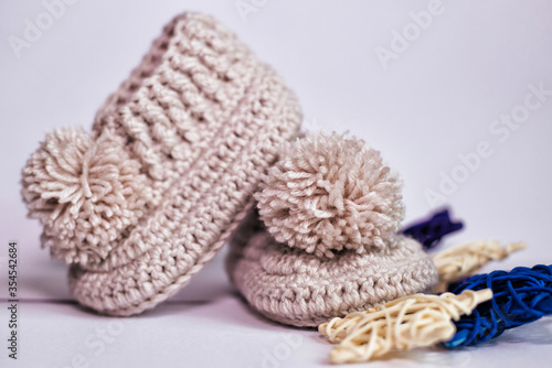 Small children's socks. Booties in gray on a white background. Wool socks for the baby.
