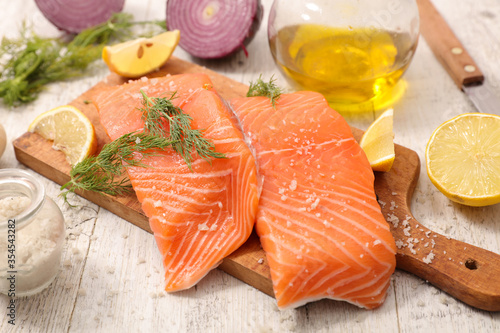 raw salmon fillet with ingredient on board