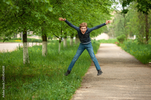 Teen jumping for joy in the park