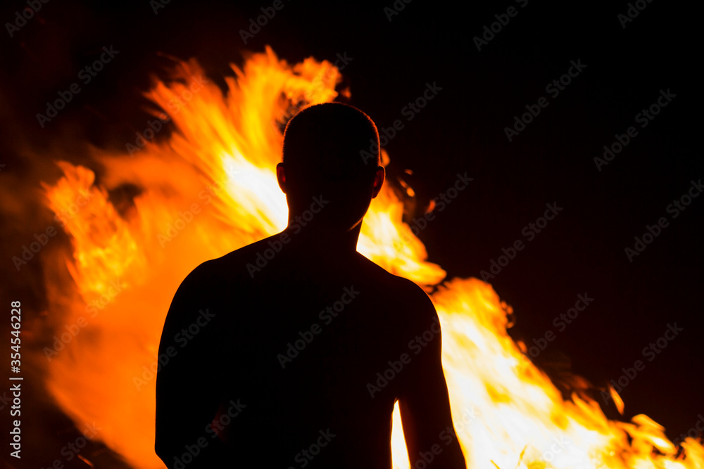 African American on the background of a burning one