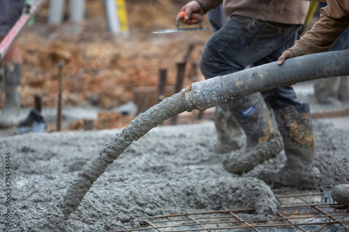 Pouring and leveling a new concrete slab for a residential house under construction in Melbourne Australia