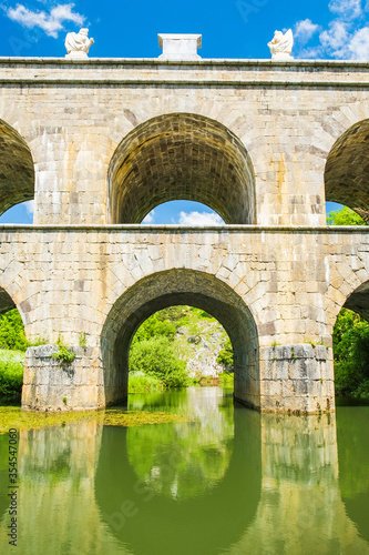 Croatia, beautiful 19 century stone bridge with arches in Tounj on Tounjcica river photo