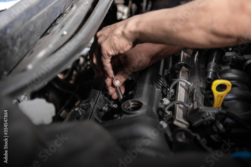 Car mechanic working on engine repair