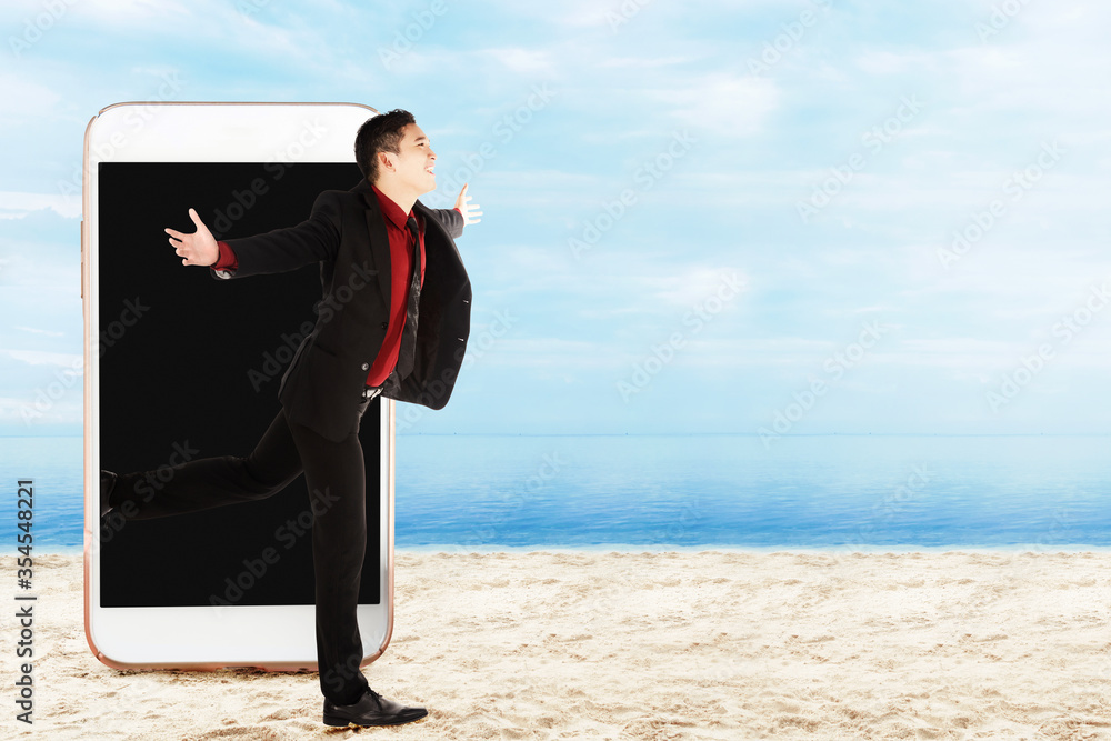 Asian businessman running from the phone screen Asian businessman running from the phone screen