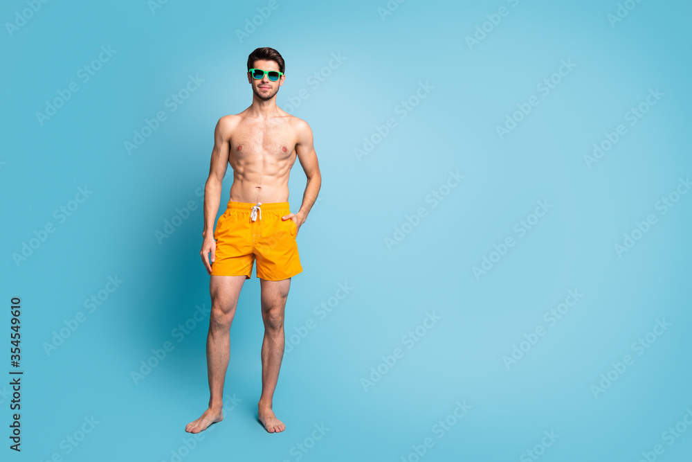 Full length body size photo of confident virile man with hands in pocket wearing eye glasses isolated pastel blue color background
