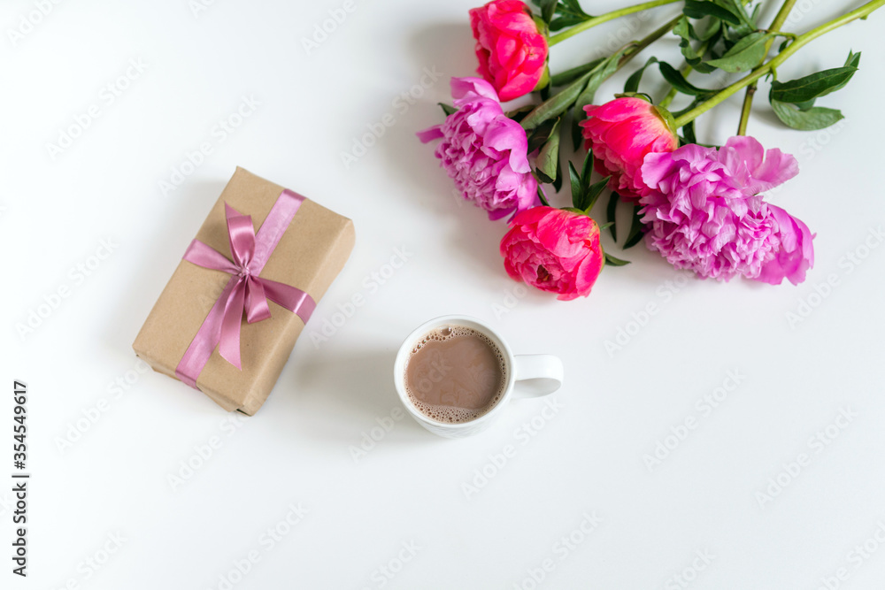 festive bouquet of peonies and gift with pink ribbon festive bouquet of peonies and gift with pink ribbon