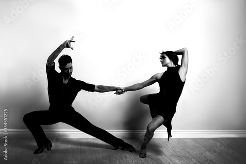 Passionate young couple dancing in modern studio