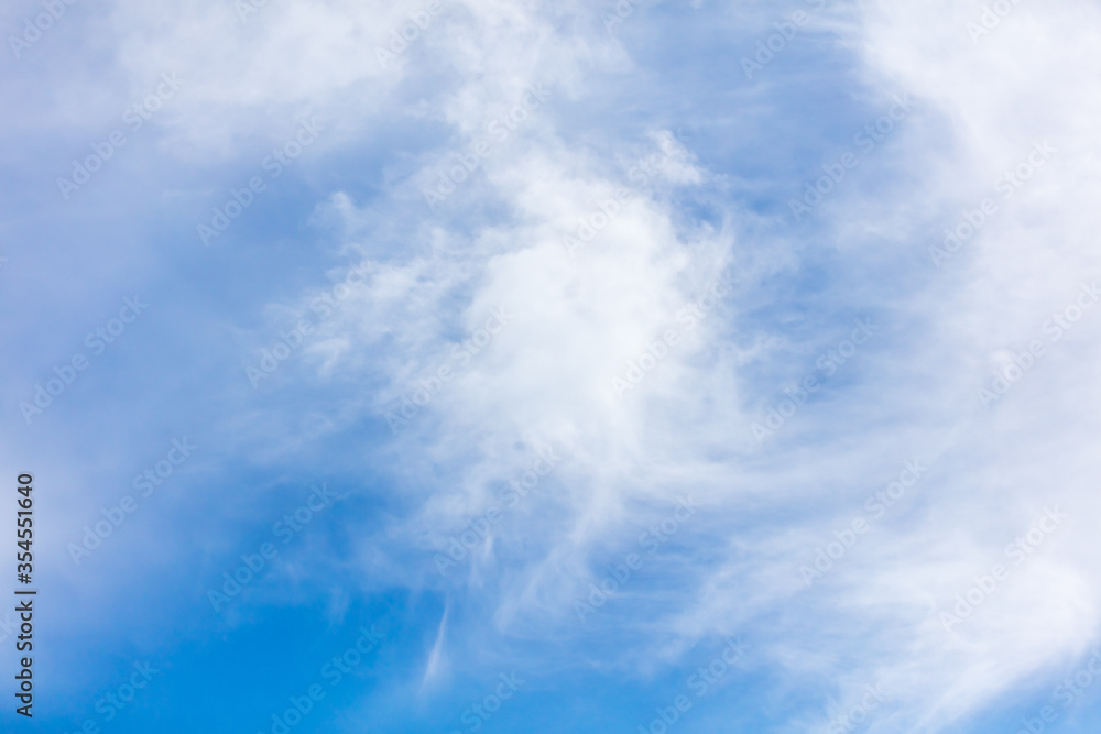 White clouds on a blue sky as background White clouds on a blue sky as background