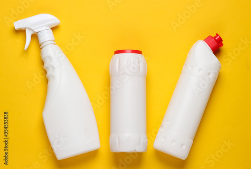 Bottles of cleaning product on yellow background. Top view. Cleaning concept. Minimalism