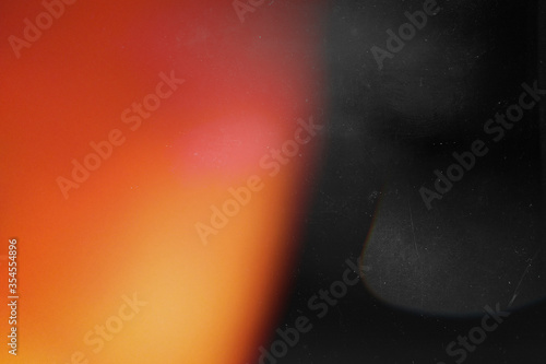 Fényképezés Orange light effect on black background