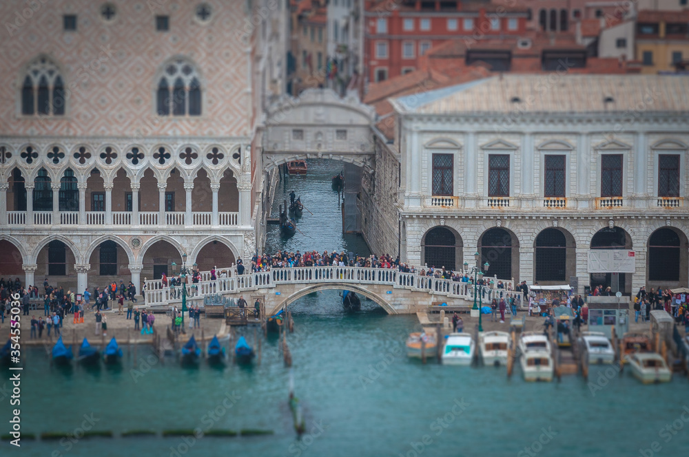 Tilt shift effect of tourists watching the Sospiri Bridge, Venice, Italy. Concept: mass tourism in Venice