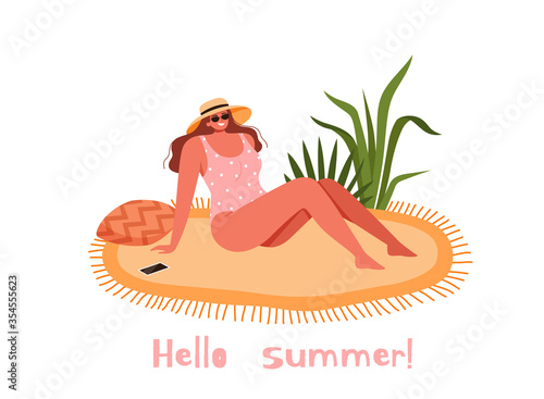Young girl in a swimsuit and hat sits on a bedspread on the beach. Woman sunbathes in the sun and enjoys a summer vacation