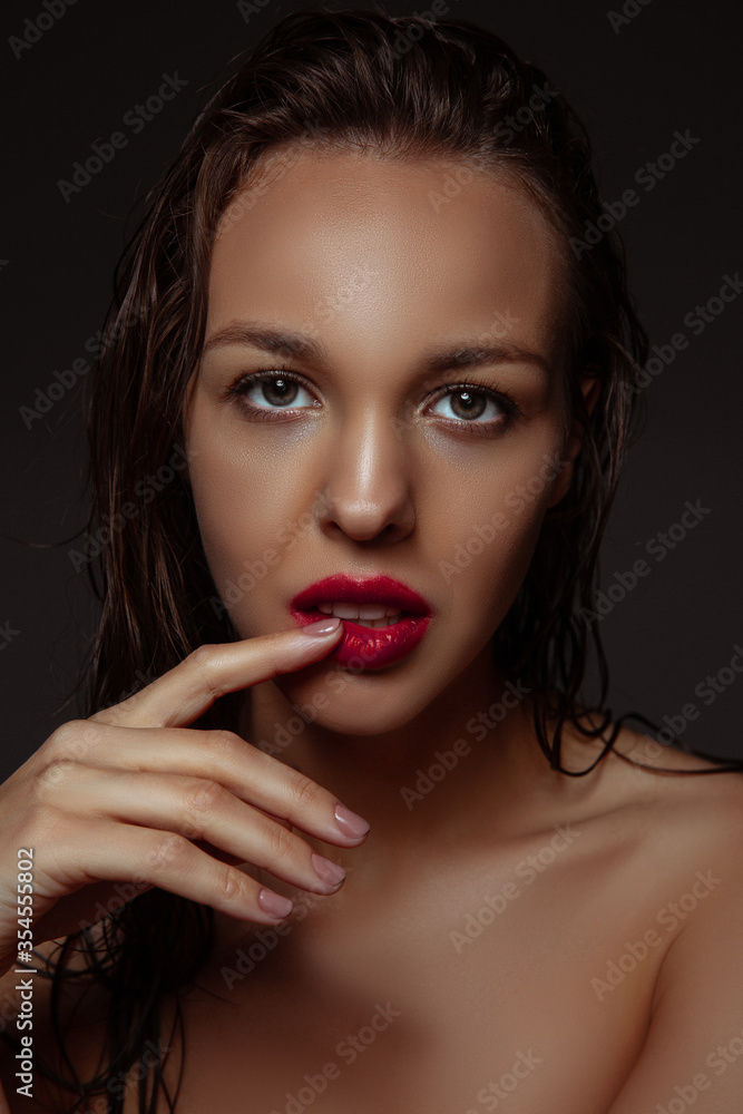 Inspired. Portrait of beautiful stylish woman isolated on dark studio background. Caucasian model with red lipstick, wet hair and shiny skin, bright make up. Beauty, fashion, emotions concept. Inspired. Portrait of beautiful stylish woman isolated on dark studio background. Caucasian model with red lipstick, wet hair and shiny skin, bright make up. Beauty, fashion, emotions concept.