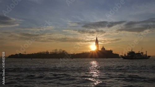 Wallpaper Mural Ferry crossing in front of the island of San Giorgio at sunset, Venice, Italy. Concept: sunset over Venice, tranquility and spirituality, travel to famous places Torontodigital.ca