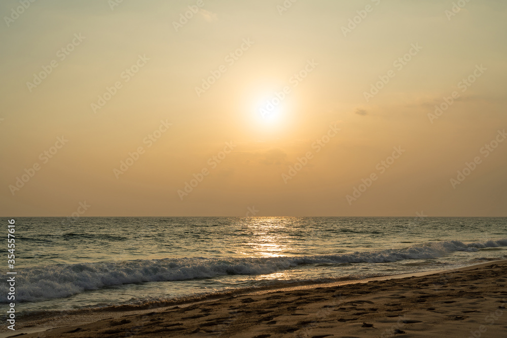 Ocean waves on sand beach, sunset landscape view, Sri Lanka