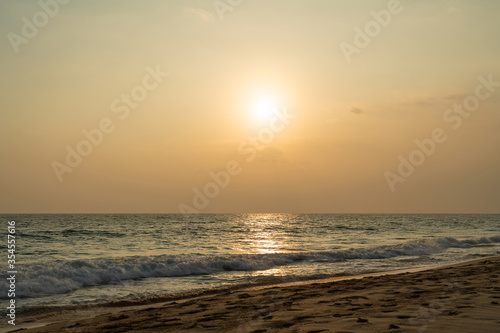 Ocean waves on sand beach, sunset landscape view, Sri Lanka