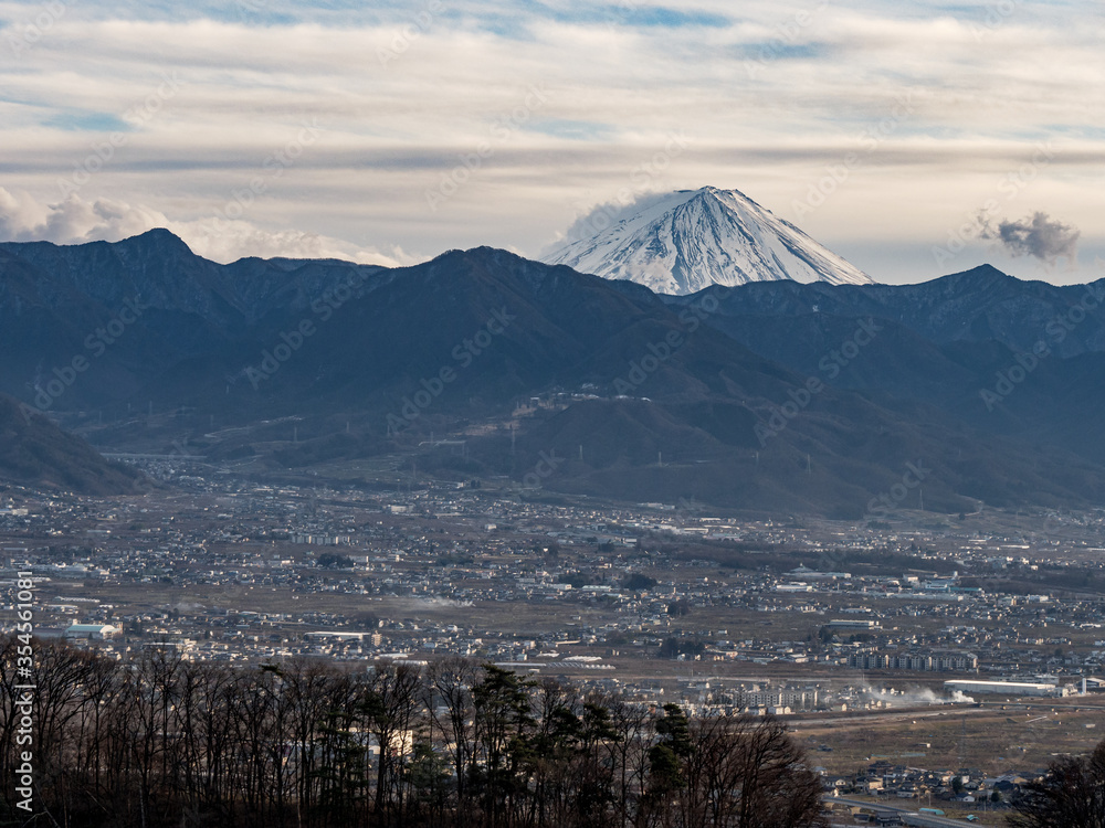 Sweeping views of a small Japanese town surrounded by mountains