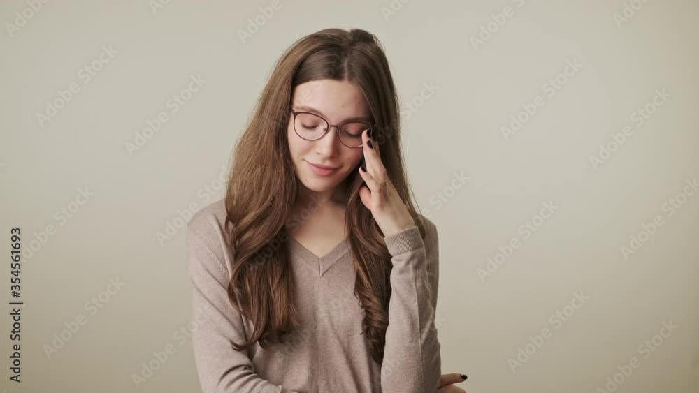 Beautiful young smiling cute pretty woman isolated over grey wall background Beautiful young smiling cute pretty woman isolated over grey wall background