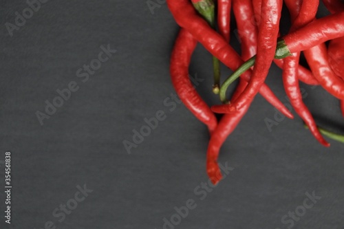 curly chili pepper on black isolated background
