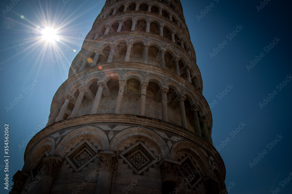 Leaning Tower of Pisa with sun and rays and lens flare