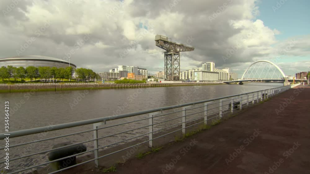 Lockdown shot of famous cable-stayed bridge over River Clyde in city against cloudy sky - Glasgow, Scotland Lockdown shot of famous cable-stayed bridge over River Clyde in city against cloudy sky - Glasgow, Scotland
